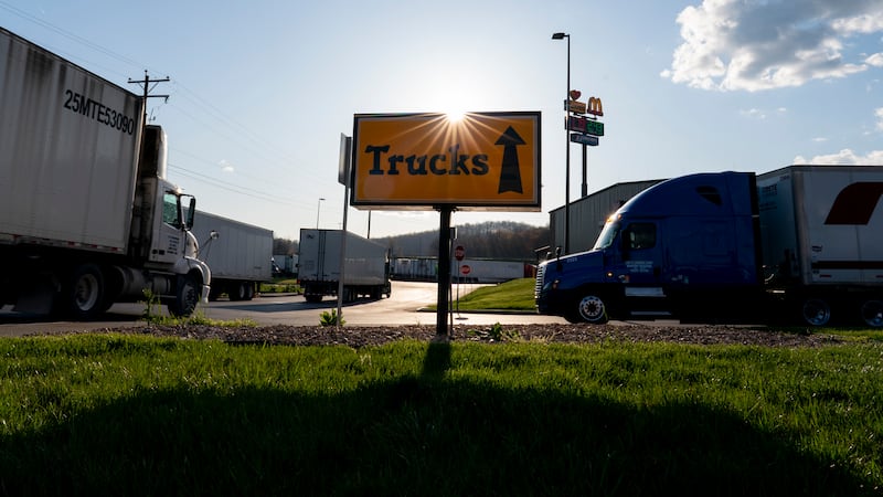 In this April 6, 2020, photo, semitrucks head to the truck parking lot at the Love's Travel...